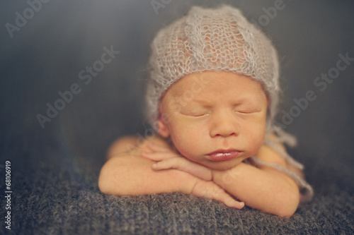 Portrait of Newborn Baby Sleeping on Hands