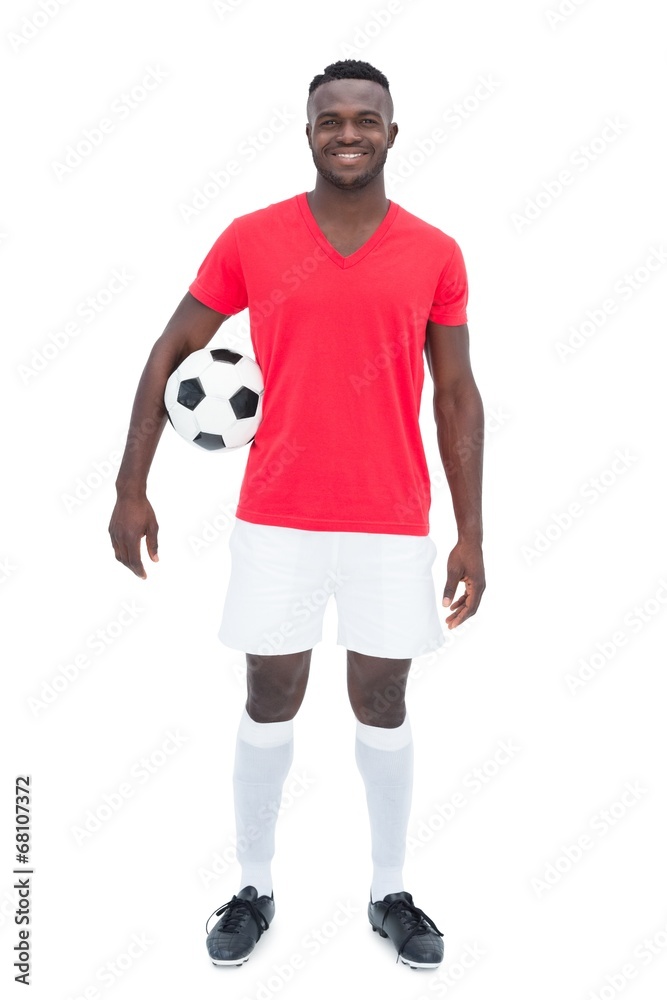 Football player in red jersey holding ball