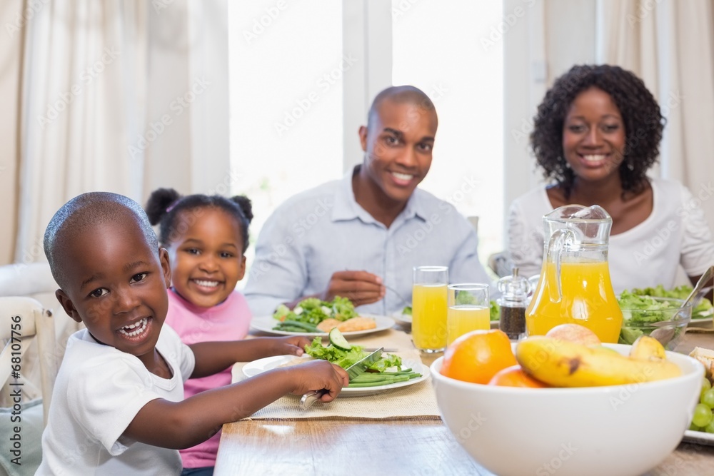 Happy family enjoying a healthy meal together Happy family enjoying a healthy meal together