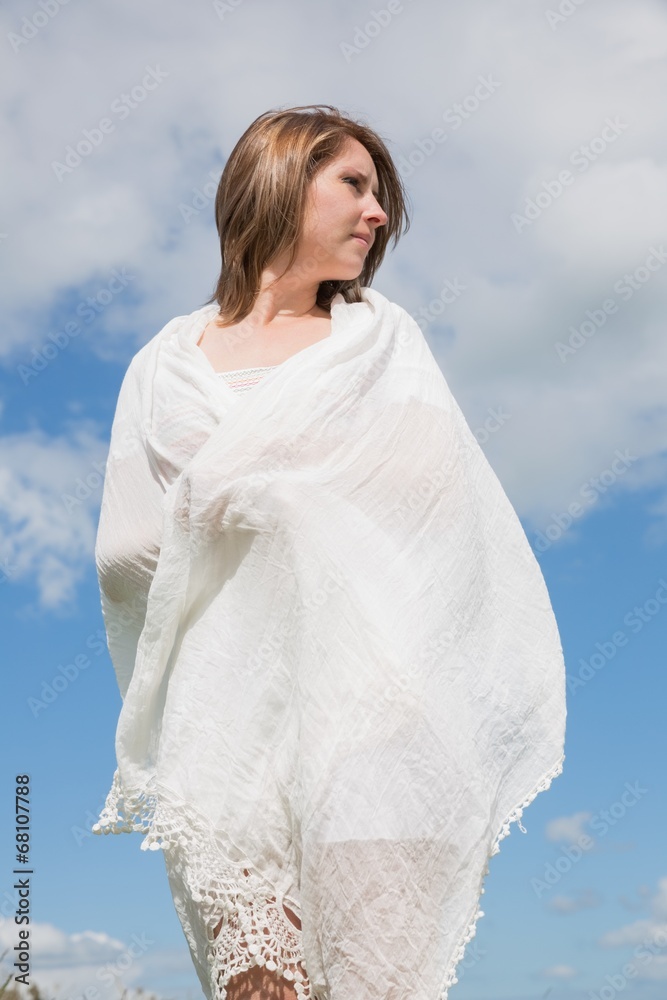 Woman looking away against blue sky and clouds Woman looking away against blue sky and clouds