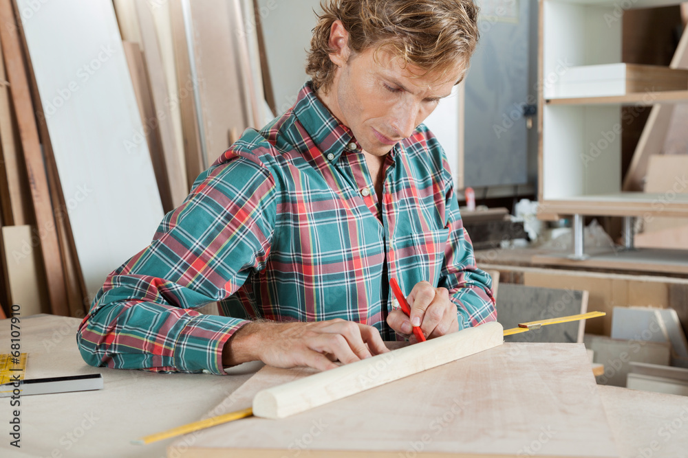 Carpenter Measuring Wood At Table Carpenter Measuring Wood At Table