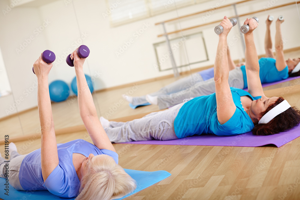 Fototapeta premium Exercising with barbells