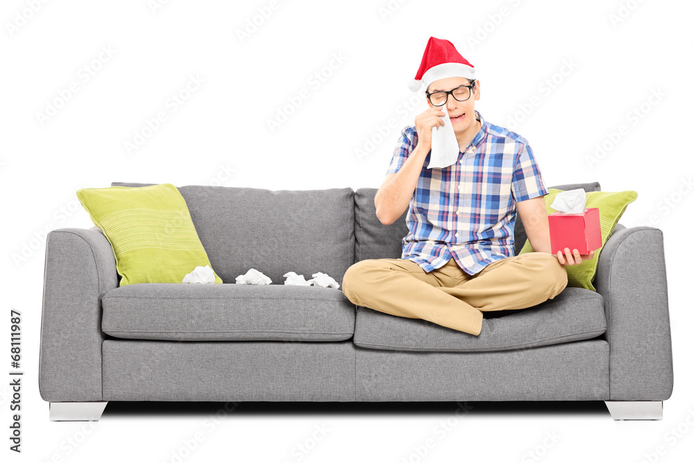 Obraz premium Sad man with Santa hat wiping his eyes from crying