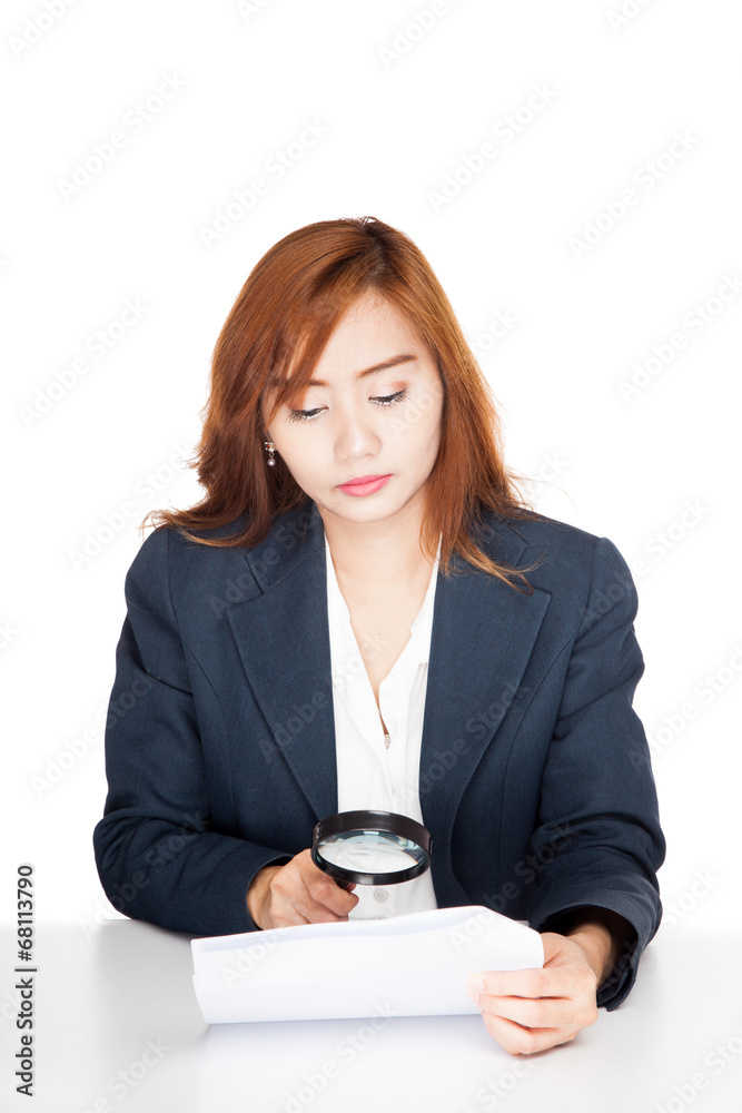 Asian office girl check data with magnifying glass Asian office girl check data with magnifying glass