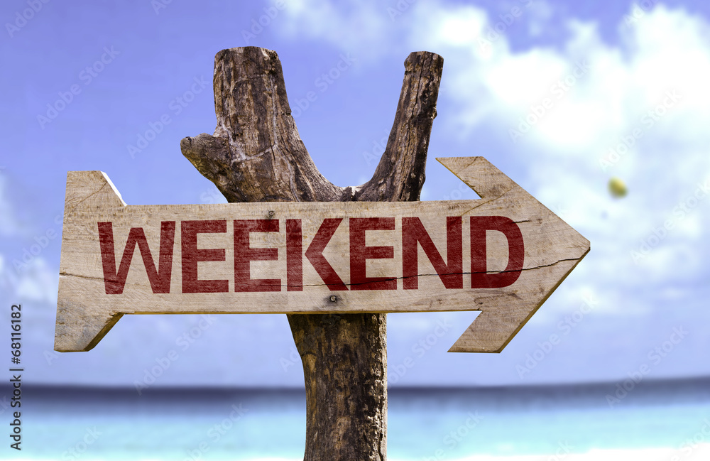 Weekend wooden sign with a beach on background