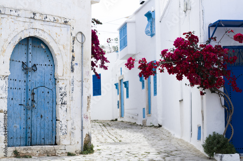 Blue doors, window and white wall of building in Sidi Bou Said #68118942