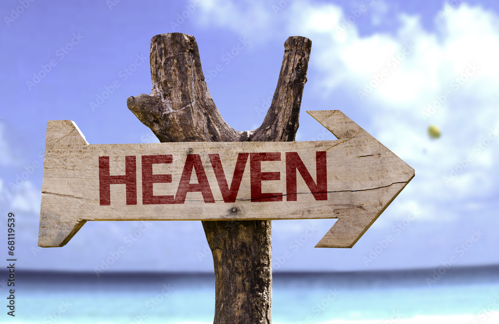 Heaven wooden sign with a beach on background
