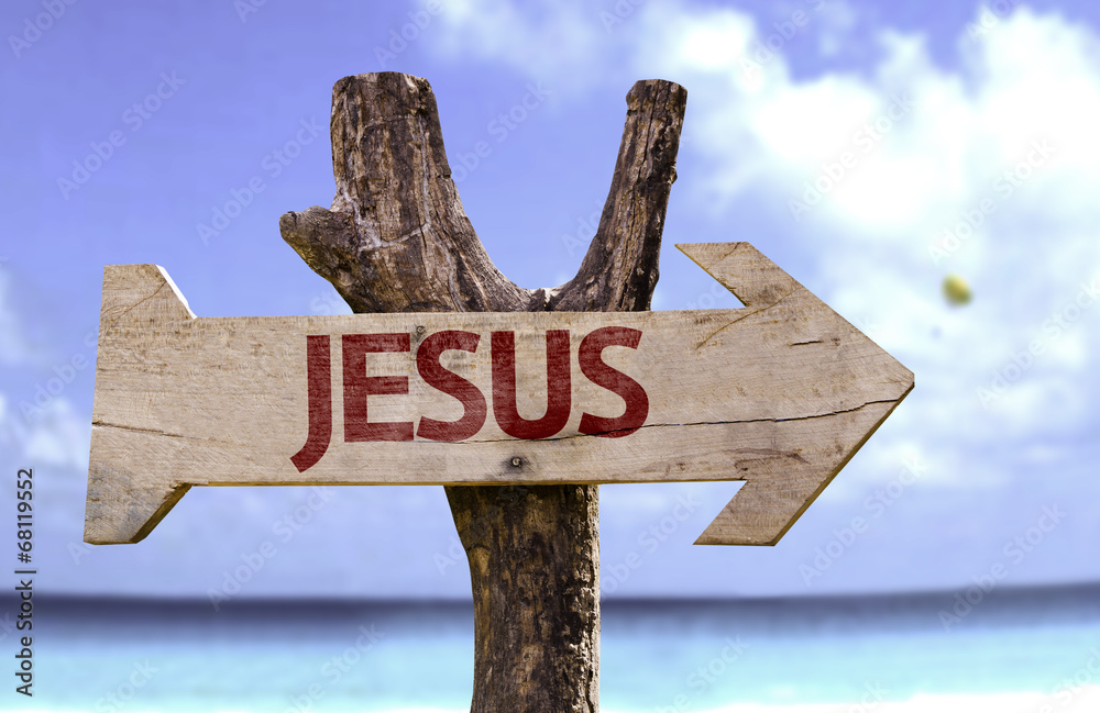 Jesus wooden sign with a beach on background