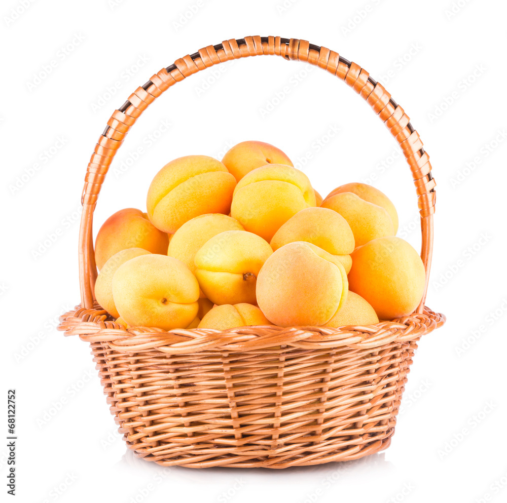 fresh apricots in a basket isolated on white background