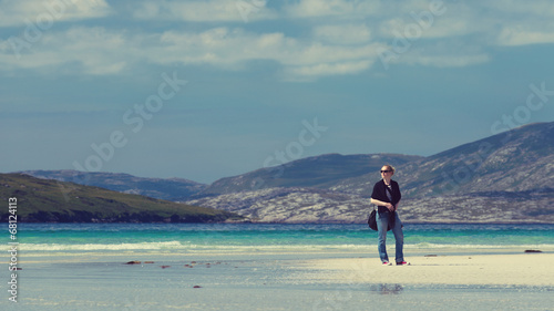 Woman enjoying holiday, white sandy beach with turquoise water