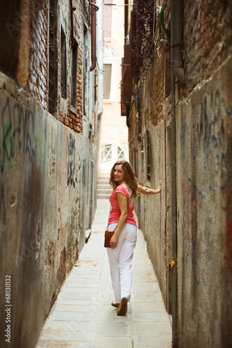 Pretty woman in narrow Venice street