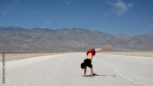 Boy dancing breakdance in the famous Death Valley USA