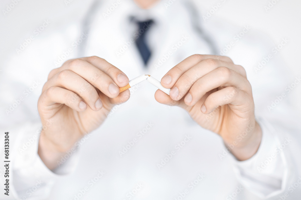 man breaking the cigarette with hands man breaking the cigarette with hands