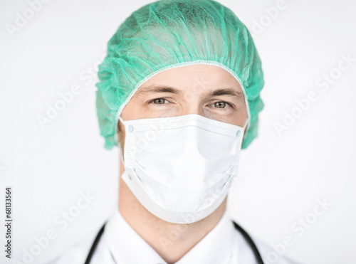 surgeon in medical cap and mask