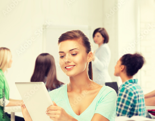 student with tablet pc in college
