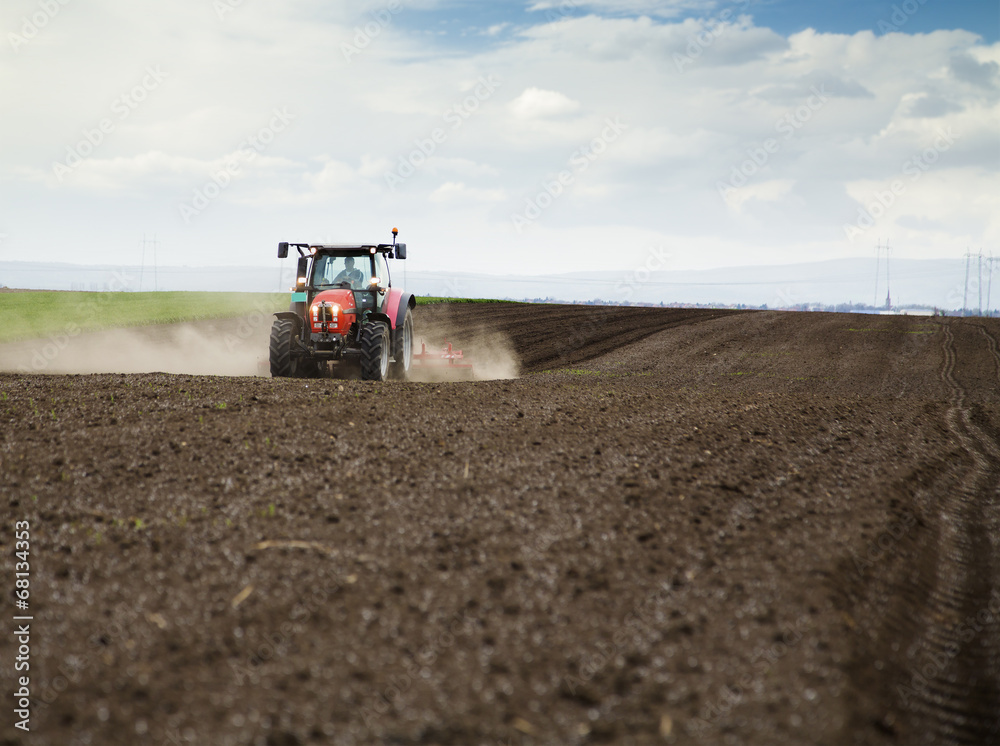 Farmer in tractor preparing land for sowing Farmer in tractor preparing land for sowing