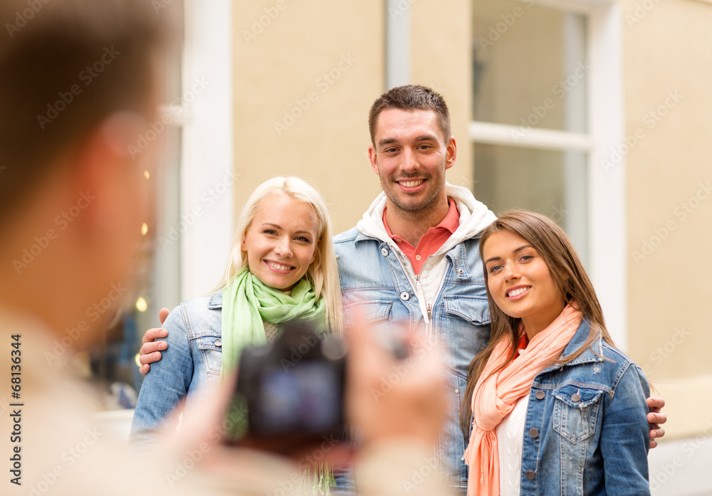 group of smiling friends taking photo outdoors group of smiling friends taking photo outdoors