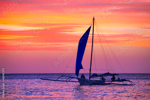 Sailing boat in the beautiful sunset.
