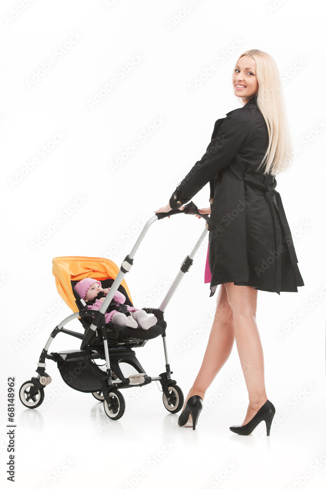 young beautiful mum with baby in stroller. young beautiful mum with baby in stroller.