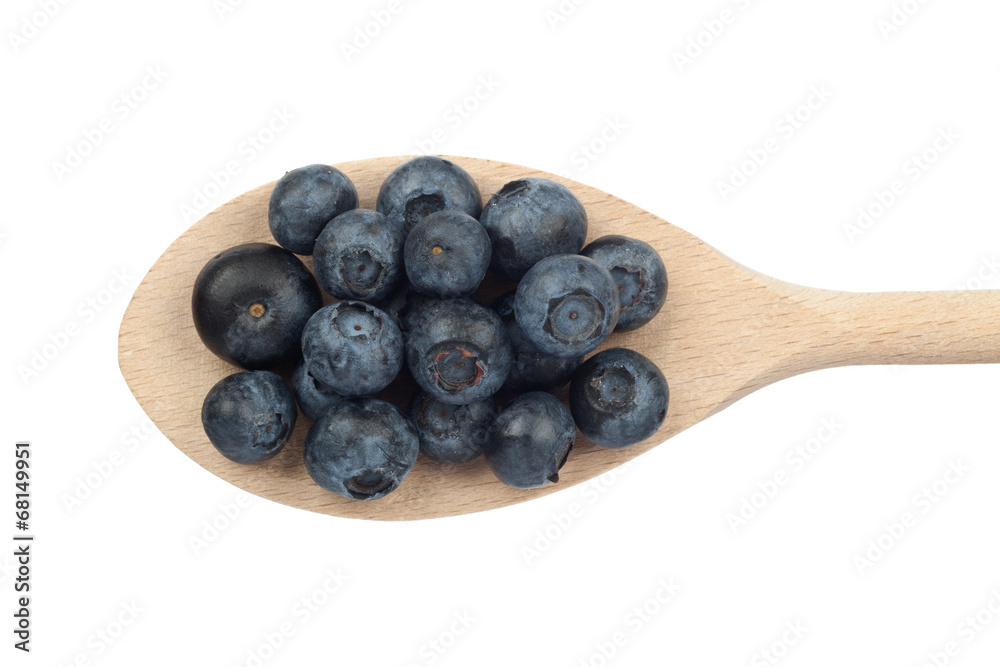 Blueberries on wooden spoon isolated on white Blueberries on wooden spoon isolated on white