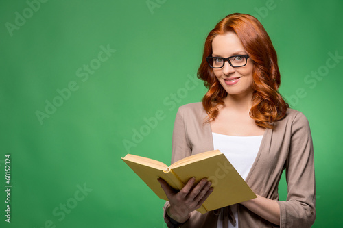 Beautiful business woman smiling over green background.