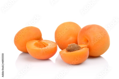 Three sliced apricots isolated on white photo
