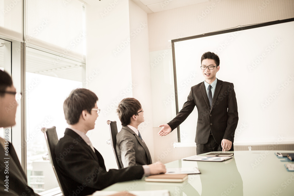 businessman giving a presentation to his colleagues businessman giving a presentation to his colleagues