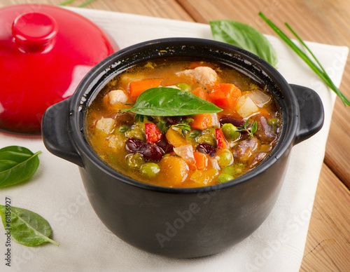 Bowl of minestrone soup with beans and vegetables.