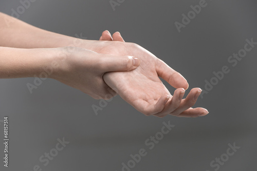 Woman holding her wrist - pain concept. photo