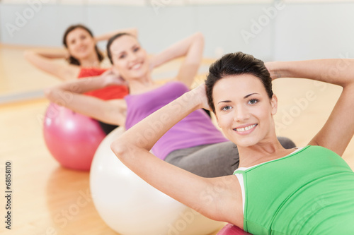 woman working out in gym doing pilates.
