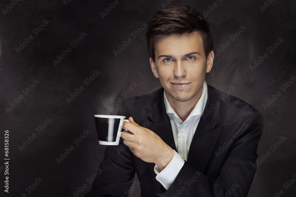 Portrait of the handsome mna holding the coffee cup Portrait of the handsome mna holding the coffee cup