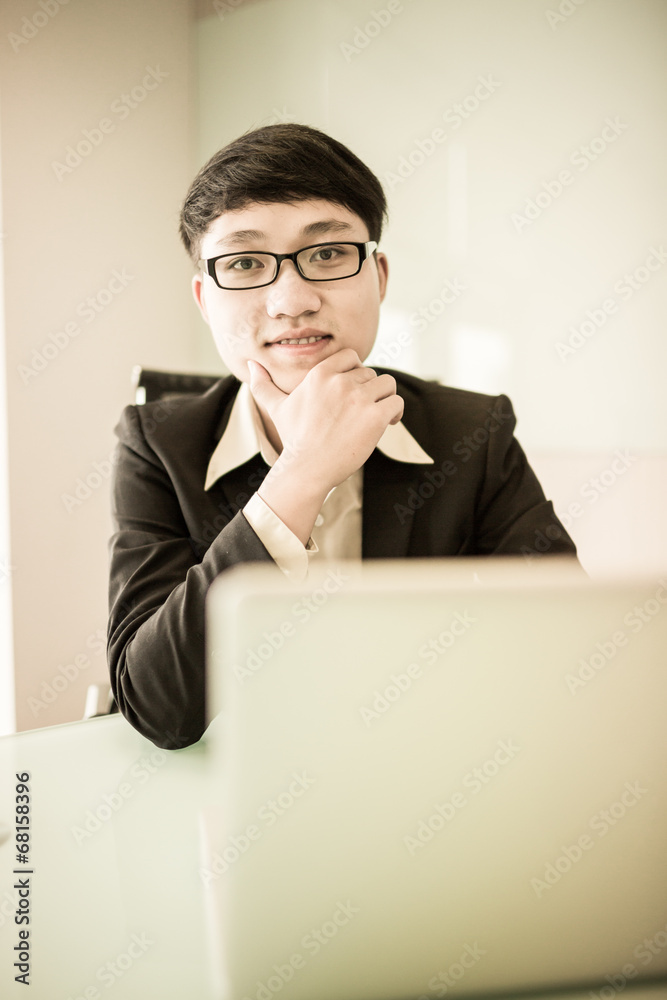 Young handsome man using laptop in his office Young handsome man using laptop in his office