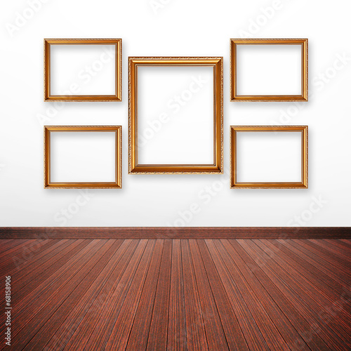 Golden picture frames on the wall inside the room © Atstock Productions