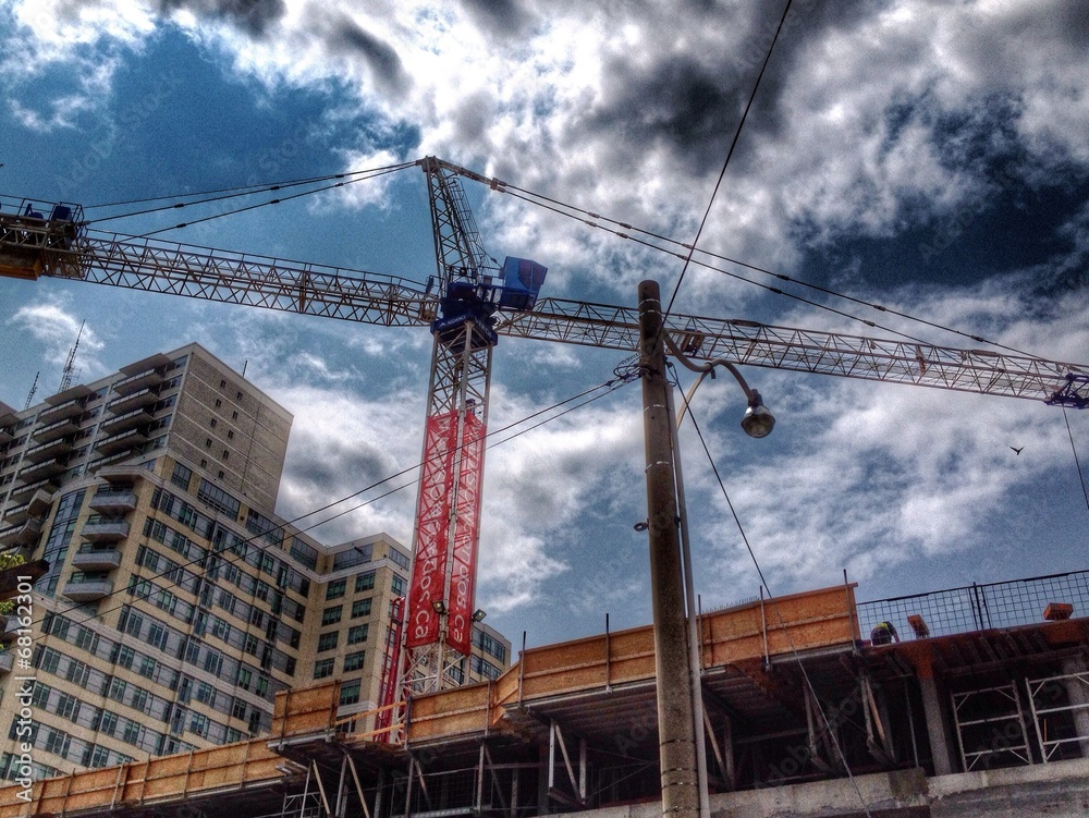 Dark clouds over high-rise building under construction Dark clouds over high-rise building under construction