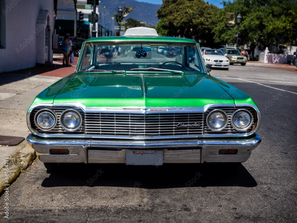 Classic Chevrolet in green serving as a taxi in Santa Barbara, C