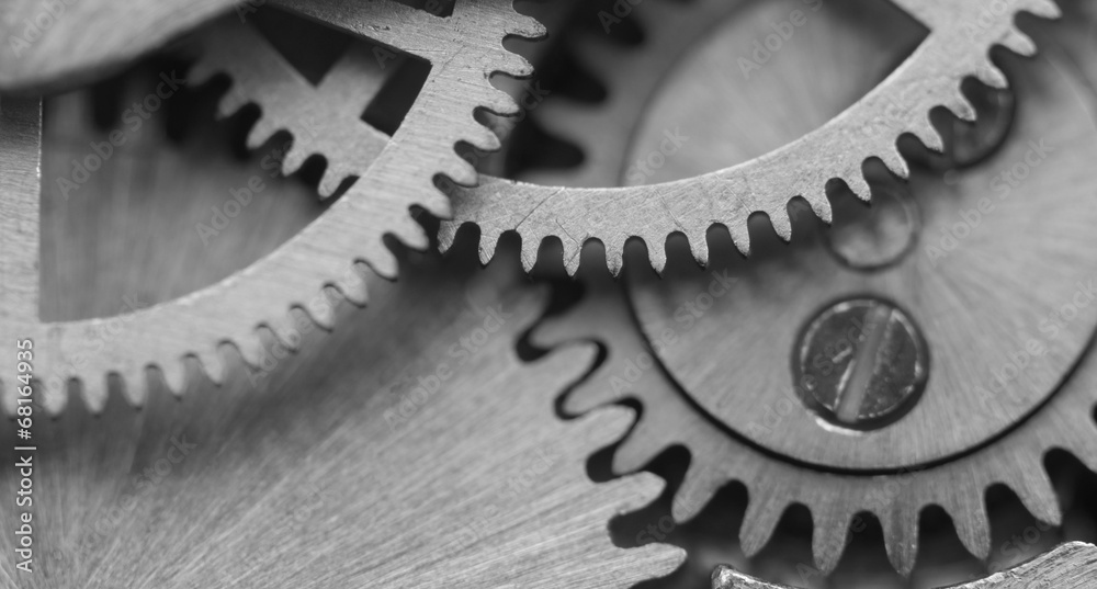 Black white background with metal cogwheels a clockwork. Macro Black white background with metal cogwheels a clockwork. Macro
