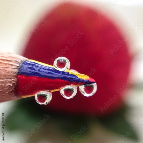 Reflections of strawberry in waterdroplets photo