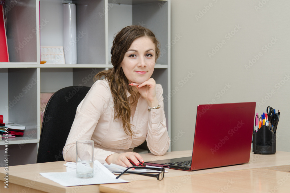 Portrait of girl at a laptop in the office Portrait of girl at a laptop in the office