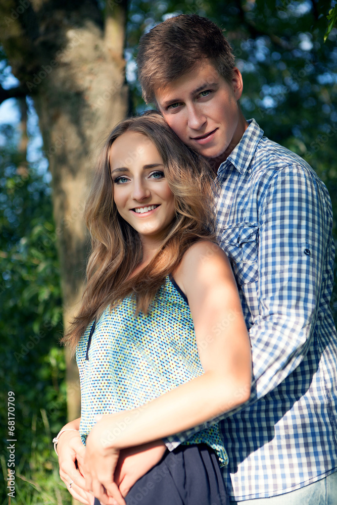 Young couple in nature on summer, looking into the camera Young couple in nature on summer, looking into the camera