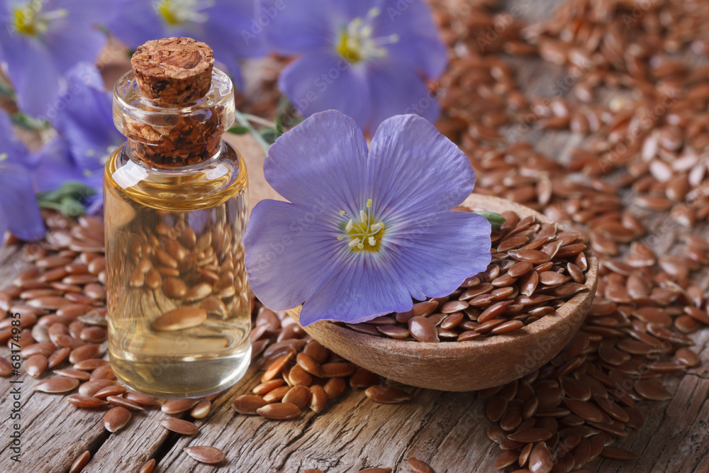 flax seeds in a spoon and oil in a bottle close-up horizontal