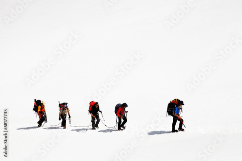 Team of alpinists crossing a glacier