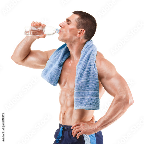 Young muscular man, drinking water, isolated on white