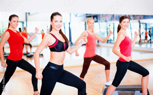 group of smiling people doing aerobics