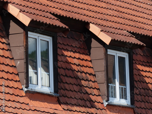 Rotes Ziegeldach mit Mansarde, Dachgaube und hohen Fenstern bei Sonnenschein im Sommer in Wettenberg Krofdorf-Gleiberg bei Gießen in Hessen photo