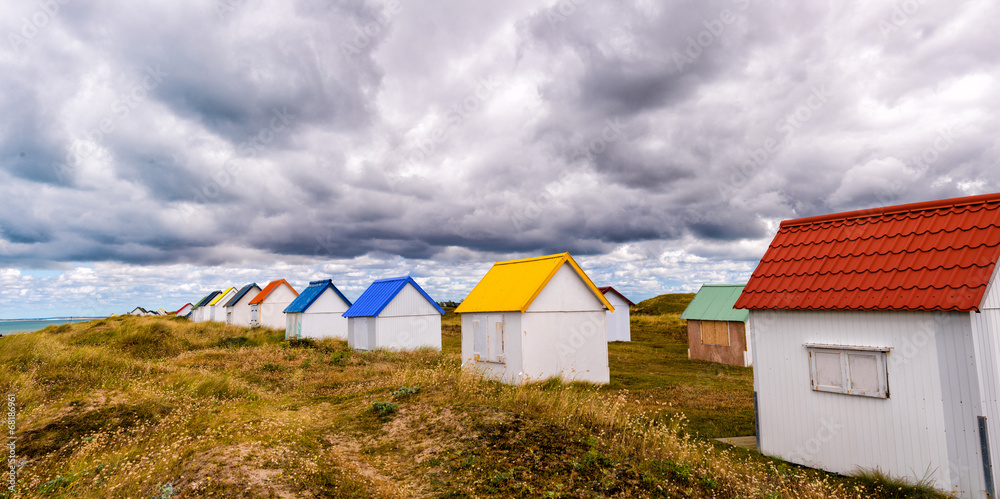 Multicolour huts over the ocean. Beautiful countryside landscape