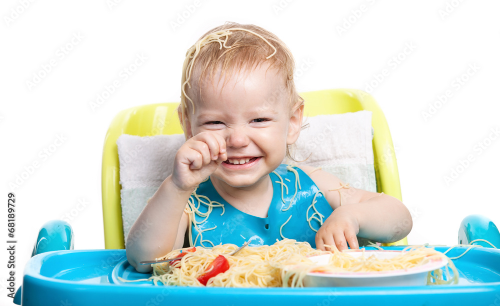 Little boy eating spaghetti with pasta on his head Little boy eating spaghetti with pasta on his head