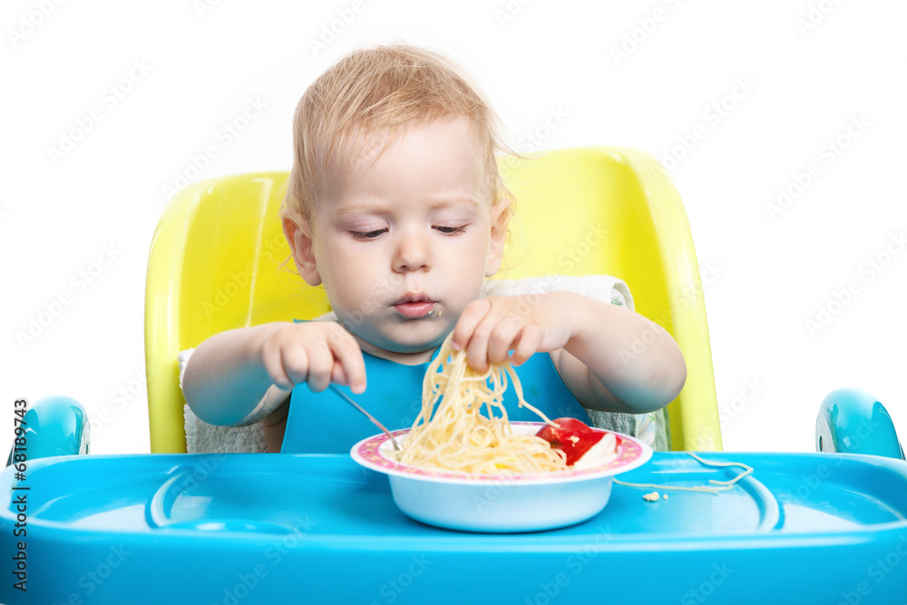 Little blond boy eating spaghetti Little blond boy eating spaghetti