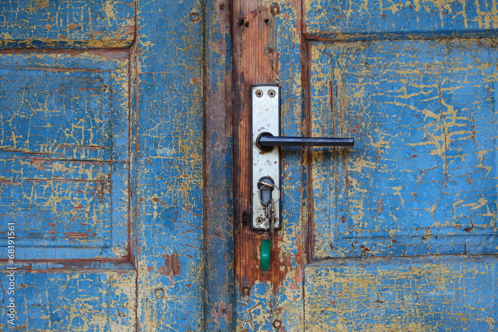 old wooden cracked blue door with handle old wooden cracked blue door with handle
