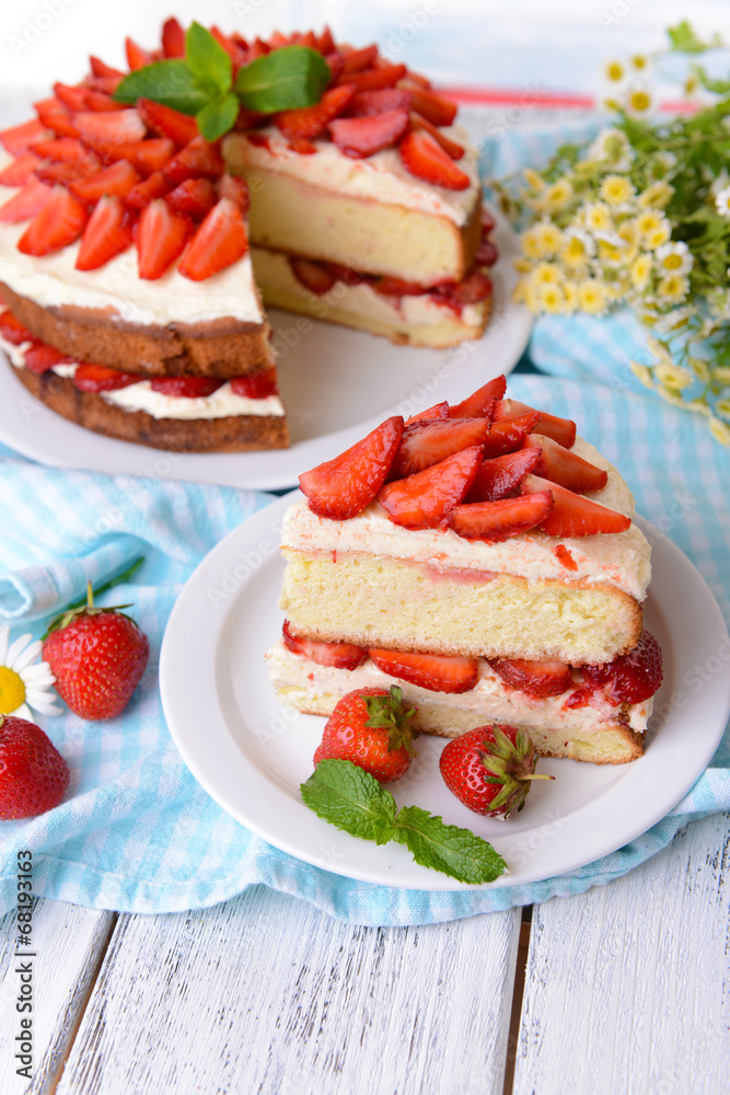 Delicious biscuit cake with strawberries on table close-up Delicious biscuit cake with strawberries on table close-up