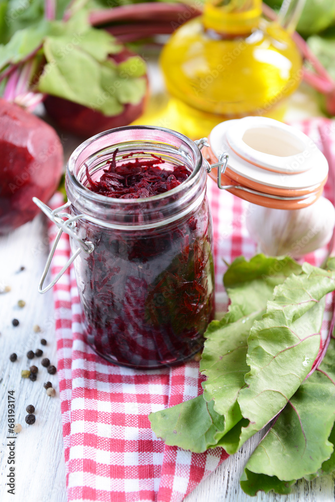 Grated beetroots in jar on table close-up